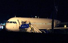 People gather atop the aircraft steps at a Syrian passenger plane that was forced by Turkish jets to land at Esenboga airport in Ankara, Turkey, Wednesday, Oct. 10, 2012. (photo credit: Burhan Ozbilici/AP)