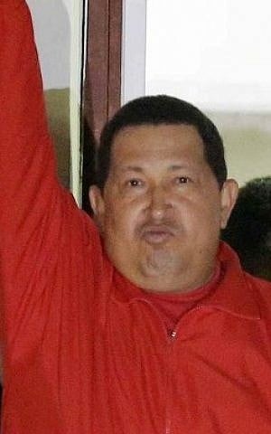 Venezuela's President Hugo Chavez greets his supporters at the Miraflores presidential palace balcony in Caracas, Venezuela, Sunday, Oct. 7, 2012. Chavez won re-election and a new endorsement of his socialist project Sunday, surviving his closest race yet after a bitter campaign against opposition candidate Henrique Capriles. (photo credit: AP Photo/Fernando Llano)