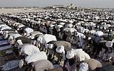Afghans pray outside a mosque on the outskirts of Jalalabad, east of Kabul. In Afghanistan, the expression of atheist views is punishable by the death penalty. (photo credit: AP/Rahmat Gul/File)