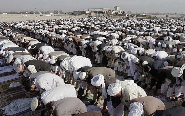 Afghans pray outside a mosque on the outskirts of Jalalabad, east of Kabul. In Afghanistan, the expression of atheist views is punishable by the death penalty. (photo credit: AP/Rahmat Gul/File) Afghans pray outside a mosque on the outskirts of Jalalabad, east of Kabul. In Afghanistan, the expression of atheist views is punishable by the death penalty. (photo credit: AP/Rahmat Gul/File)