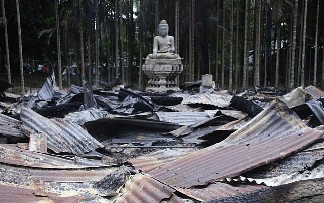 A Buddha statue stands amidst the ruins of a Buddhist temple that was torched Sunday by Muslims over a derogatory photo of the Quran on Facebook. The temple is located in the coastal district of Cox's Bazar, Bangladesh. (photo credit: AP Photo) A Buddha statue stands amidst the ruins of a Buddhist temple that was torched Sunday by Muslims over a derogatory photo of the Quran on Facebook. The temple is located in the coastal district of Cox's Bazar, Bangladesh. (photo credit: AP Photo)