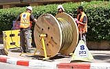 Bezeq workers installing fiber optic cables. (Courtesy)