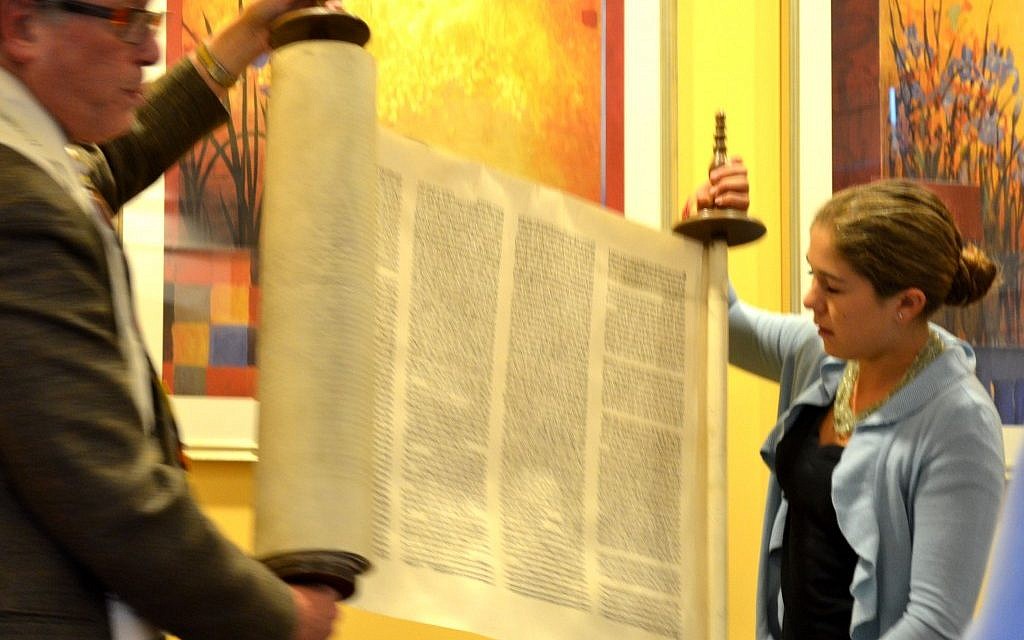 Charlotte Smith and Rabbi Jerry Levy dedicate the family Torah scroll rescued by her great-great-grandfather. (Julie Ann Kodmur via JTA) Charlotte Smith and Rabbi Jerry Levy dedicate the family Torah scroll rescued by her great-great-grandfather. (Julie Ann Kodmur via JTA)
