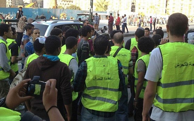 Wearing vests painted with the slogan 'Anti-harassment', a group of volunteers confront a group of teasing young boys near Cairo's Tahrir Square. Instead of taking to the streets with air horns and toy guns and hissing at women like many of their peers, the small group of young Egyptian men tried to secure the streets of downtown Cairo during Eid al-adha, one of Islam’s most important holidays, a time when fears of sexual harassment spike. Their effort largely failed, but it shows the extent of the sexual harassment scourge facing Egypt and the government’s failures to address it. (AP Photo/ Maggie Fick) Wearing vests painted with the slogan 'Anti-harassment', a group of volunteers confront a group of teasing young boys near Cairo's Tahrir Square. Instead of taking to the streets with air horns and toy guns and hissing at women like many of their peers, the small group of young Egyptian men tried to secure the streets of downtown Cairo during Eid al-adha, one of Islam’s most important holidays, a time when fears of sexual harassment spike. Their effort largely failed, but it shows the extent of the sexual harassment scourge facing Egypt and the government’s failures to address it. (AP Photo/ Maggie Fick)