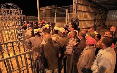 Palestinians line up before dawn to cross a checkpoint near Beersheba to attend work in Israel (Tsafrir Abayov/Flash90/File)
