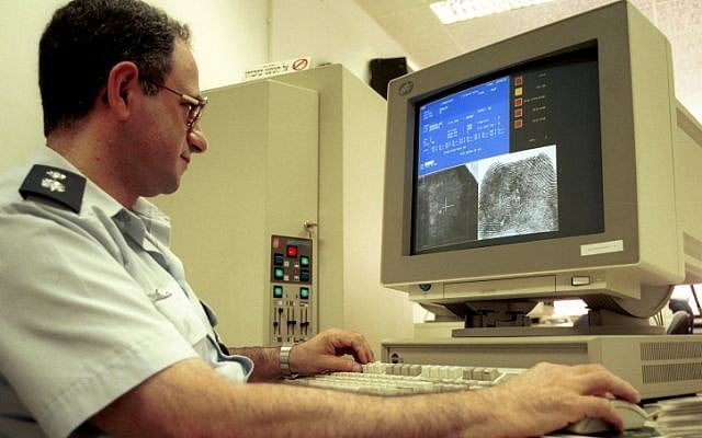 A policeman uses a computer to identify fingerprints in a laboratory at the police headquarters (Yossi Zamir/Flash90) A policeman uses a computer to identify fingerprints in a laboratory at the police headquarters (Yossi Zamir/Flash90)