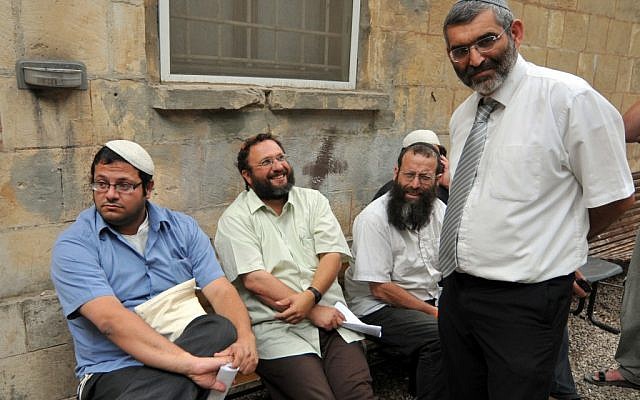 Itamar Ben-Gvir, left, with Baruch Marzel, seated on far right and Michael Ben-Ari, standing, with a fourth unidentified man outside a police station in Jerusalem in 2010. (photo credit: Flash90)
