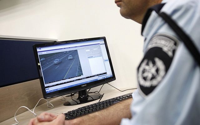 A traffic cop on a computer. (illustrative photo: Miriam Alster/Flash90)
