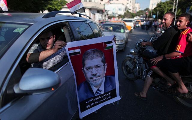 Gaza residents celebrate the victory of Mohammed Morsi in Egypt's elections, June 24 (photo credit: Wissam Nassar/Flash90)