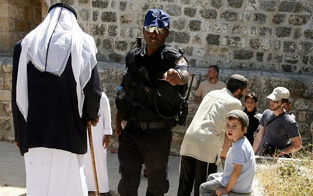 Illustrative photo of an Israeli police officer with Muslims and Jews at the entrance to the Temple Mount in July 2012 (photo credit: Mahfouz Abu Turk/Flash90)