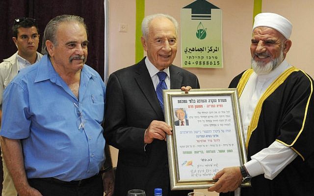 President Shimon Peres with the head of the Arab community in Majd al-Krum on August 21, 2012 (photo credit: Mark Neyman/GPO/Flash90)