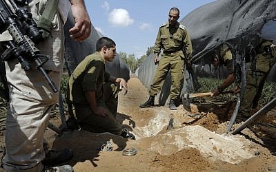 Members of the IDF's bomb squad search for a mortar shell in a greenhouse near Israel's border with the Gaza Strip after it was fired by Palestinian terrorists on Monday. Israeli forces and Palestinian terrorists exchanged fire on Monday in the most serious flare-up in months along the border with the Gaza Strip, officials said. (Tsafrir Abayov/Flash90).
