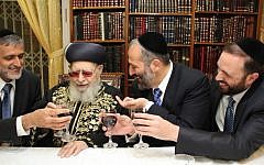 Shas founder Rabbi Ovadia Yosef (center) flanked on the left by MK Eli Yishai and on the right by MKs Aryeh Deri and Ariel Atias, at the rabbi's house in Jerusalem, October 2012. (photo credit: Shas/Flash90)