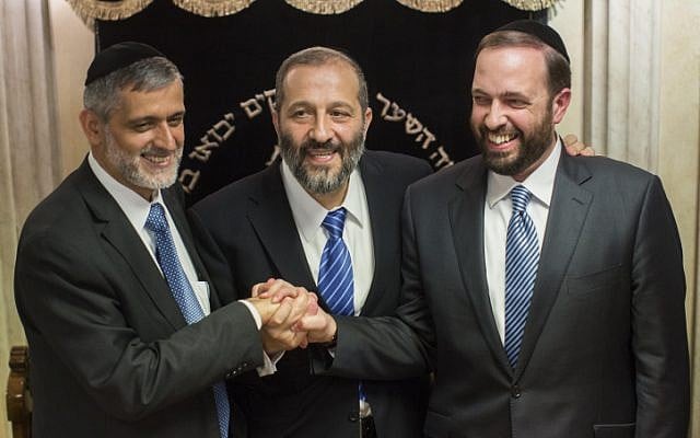 File: Left to right: Interior Minister Eli Yishai , former Shas party chairman Aryeh Deri, and Housing Minister Ariel Atias talk to the press Oct. 17,  2012, after announcing a power-sharing deal for the leadership of the religious Shas Party (photo credit: Yonatan Sindel/Flash90)