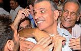 Then-minister of communications Moshe Kahlon is embraced and congratulated by Likud members at a party convention held in Tel Aviv on October 17, 2012. (Yossi Zeliger/Flash90)