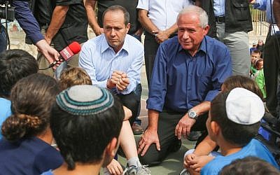Home Front Defence Minister Avi Dichter, right, and Jerusalem Mayor Nir Barkat speak to students during an earthquake drill in their school, in Jerusalem on Sunday, Oct. 21 (photo credit: Oren Nahshon/Flash90)
