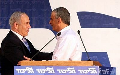 Prime Minister Benjamin Netanyahu embraces outgoing Minister Moshe Kahlon at the Likud Central Committee meeting in Tel Aviv on Monday (photo credit: Roni Schutzer/FLASH90)
