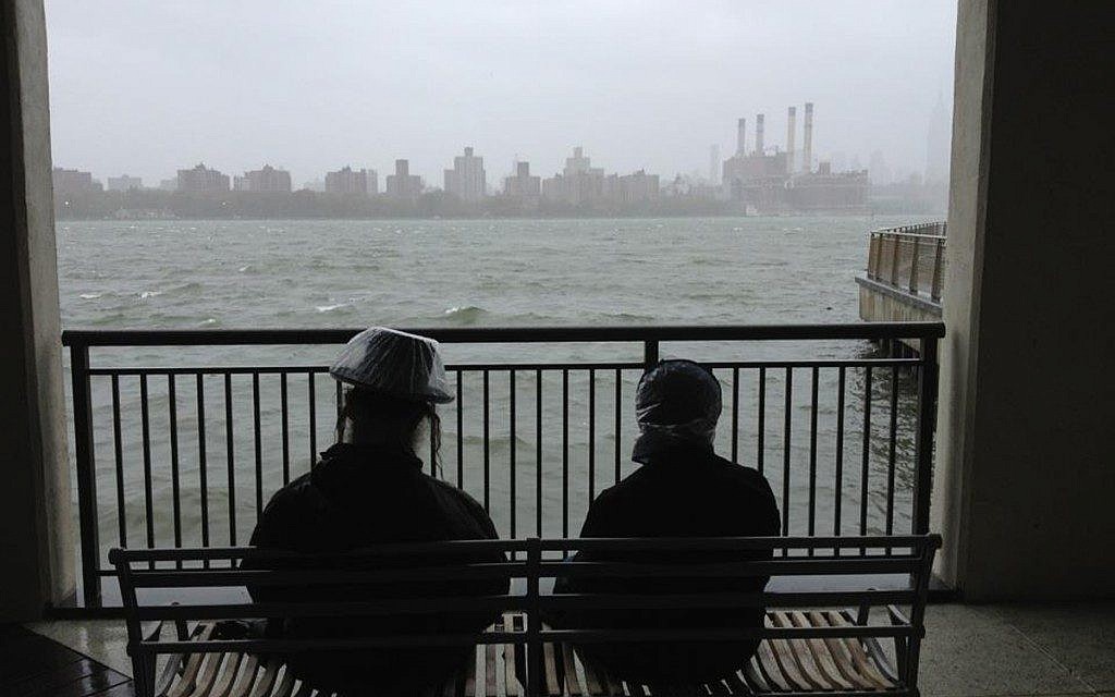 A Haredi couple awaits the arrival of Hurricane Sandy on Monday in Brooklyn. (Azi Paybarah via Twitter/JTA) A Haredi couple awaits the arrival of Hurricane Sandy on Monday in Brooklyn. (Azi Paybarah via Twitter/JTA)