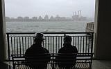 A Haredi couple awaits the arrival of Hurricane Sandy on Monday in Brooklyn. (Azi Paybarah via Twitter/JTA)