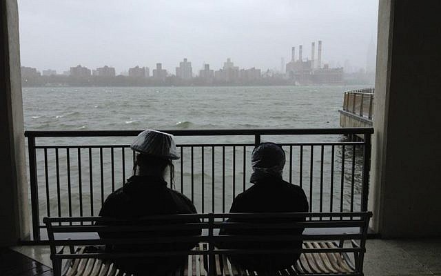 A Haredi couple awaits the arrival of Hurricane Sandy on Monday in Brooklyn. (Azi Paybarah via Twitter/JTA)