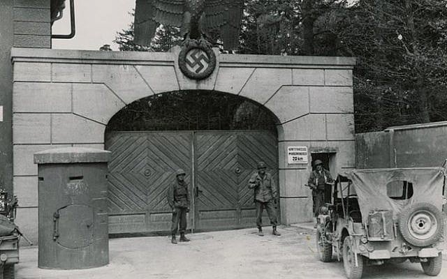 US troops guard the main entrance to the Dachau concentration camp, just after liberation in 1945 (photo credit: US National Archives/Wikimedia Commons)