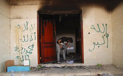 An investigator searching the US consulate in Benghazi the day after the Sept. 11 attack. (photo credit: AP/Ibrahim Alaguri)