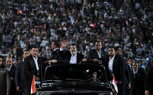 Egyptian President Mohammed Morsi waves to a Cairo crowd in October before making a speech on the national holiday that marks Egypt's 1973 war with Israel (photo credit: AP/Egyptian Presidency) Egyptian President Mohammed Morsi waves to a Cairo crowd in October before making a speech on the national holiday that marks Egypt's 1973 war with Israel (photo credit: AP/Egyptian Presidency)
