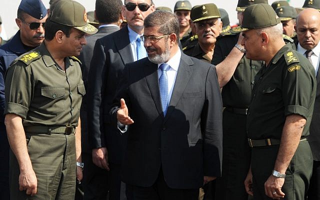 Egyptian President Mohammed Morsi with Minister of Defense, Lt. Gen. Abdel-Fattah el-Sissi, left, at a military base in Ismalia, Egypt, Wednesday(photo credit: AP/Egyptian Presidency)