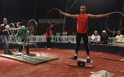 In this photo taken Thursday, Oct. 25, 2012, Mohammed Nassar, 33, right, a member of the Egyptian National Circus practices in Gaza City. (photo credit: AP)