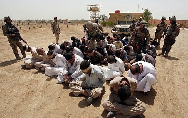 Blindfolded and handcuffed suspected al-Qaida members are guarded by Iraqi army soldiers in an Iraqi army base in Hillah, about 60 miles south of Baghdad, Iraq, on Friday, July 20, 2012. (photo credit: Alaa al-Marjani/AP) Blindfolded and handcuffed suspected al-Qaida members are guarded by Iraqi army soldiers in an Iraqi army base in Hillah, about 60 miles south of Baghdad, Iraq, on Friday, July 20, 2012. (photo credit: Alaa al-Marjani/AP)