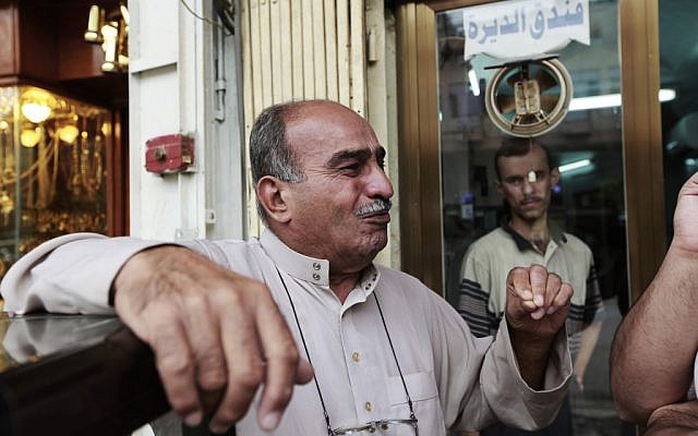 Baghdad moneylender Rasheed al-Sheikh reacts during an interview with the Associated Press after being asked about threats made against Syria's Sayyida Zainab shrine, on October 22, 2012 (photo credit: AP Photo/Hadi Mizban) Baghdad moneylender Rasheed al-Sheikh reacts during an interview with the Associated Press after being asked about threats made against Syria's Sayyida Zainab shrine, on October 22, 2012 (photo credit: AP Photo/Hadi Mizban)
