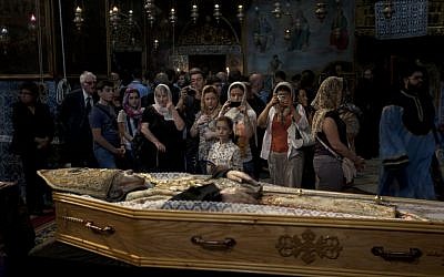 Armenians attend the funeral of the Armenian Patriarch of Jerusalem Torkom Manougian in the Old city of Jerusalem on Monday (photo credit: AP/Sebastian Scheiner)