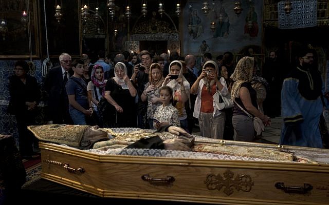 Armenians attend the funeral of the Armenian Patriarch of Jerusalem Torkom Manougian in the Old city of Jerusalem on Monday (photo credit: AP/Sebastian Scheiner) Armenians attend the funeral of the Armenian Patriarch of Jerusalem Torkom Manougian in the Old city of Jerusalem on Monday (photo credit: AP/Sebastian Scheiner)