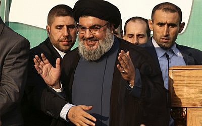 Hezbollah chief Hassan Nasrallah waves to supporters in southern Beirut, September 17 (photo credit: AP/Hussein Malla)