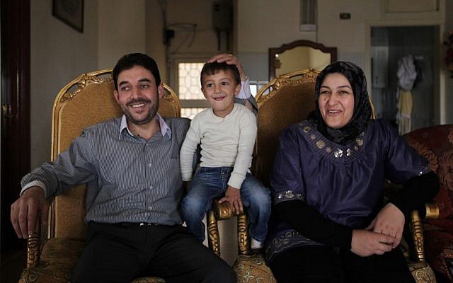 Bassel Hojeiri, 37, principal of the local middle school, with his wife, Hanan, and their son Muhammed in Arsal, a Sunni Muslim town eastern Lebanon near the Syrian border (photo credit: AP Photo/Bilal Hussein)