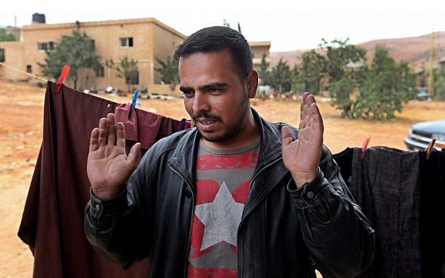Peach farmer-turned-fighter Mohammed Yousef, 25, speaks at his house in Arsal, a Sunni Muslim town eastern Lebanon near the Syrian border (photo credit: AP Photo/Bilal Hussein)