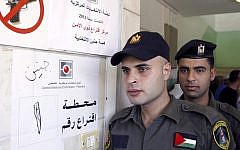 Palestinian security officers wait to cast their early votes during local elections at a polling station in the West Bank town of Jenin on Thursday. Members of Palestinian security forces cast an early vote ahead of local elections, which are taking place Saturday, in the first such polls since 2006.(photo credit: AP Photo/Mohammed Ballas)