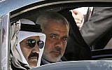 Qatari Emir Sheikh Hamad bin Khalifa al-Thani, left, and Gaza's Hamas prime minister Ismail Haniyeh, right, arrive for a cornerstone-laying ceremony for Hamad, a new residential neighborhood in Khan Younis, southern Gaza Strip, October 23, 2012. AP/Mohammed Salem.