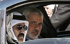 Qatari Emir Sheikh Hamad bin Khalifa al-Thani, left, and Gaza's Hamas prime minister Ismail Haniyeh, right, arrive for a cornerstone-laying ceremony for Hamad, a new residential neighborhood in Khan Younis, southern Gaza Strip, October 23, 2012. AP/Mohammed Salem.