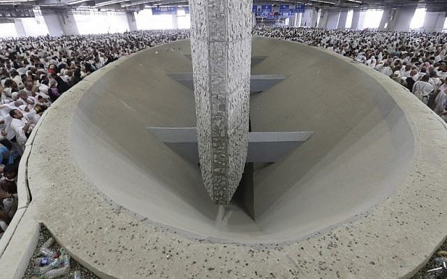 Muslim pilgrims cast stones at a pillar symbolizing the stoning of Satan, in a ritual called 'Jamarat,' a rite of the annual hajj, the Islamic faith's most holy pilgrimage, in Mina near the Saudi holy city of Mecca, Saudi Arabia, Friday, Oct. 26, 2012. The five-day rituals of hajj began on October 24, when millions arrived in the holy city of Mecca, and continues for another two days. (AP Photo/Hassan Ammar) Muslim pilgrims cast stones at a pillar symbolizing the stoning of Satan, in a ritual called 'Jamarat,' a rite of the annual hajj, the Islamic faith's most holy pilgrimage, in Mina near the Saudi holy city of Mecca, Saudi Arabia, Friday, Oct. 26, 2012. The five-day rituals of hajj began on October 24, when millions arrived in the holy city of Mecca, and continues for another two days. (AP Photo/Hassan Ammar)
