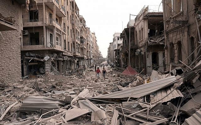 Men walk along a street between destroyed buildings where bombs rocked the Saadallah al-Jabri Square in Aleppo, Syria, on Wednesday, Oct. 3, 2012. (photo credit: SANA/AP) Men walk along a street between destroyed buildings where bombs rocked the Saadallah al-Jabri Square in Aleppo, Syria, on Wednesday, Oct. 3, 2012. (photo credit: SANA/AP)