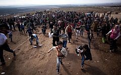 Displaced Syrian children run after a truck loaded with presents for Eid Al-Adha in a refugee camp in Idlib province, Syria, l(AP/Manu Brabo)