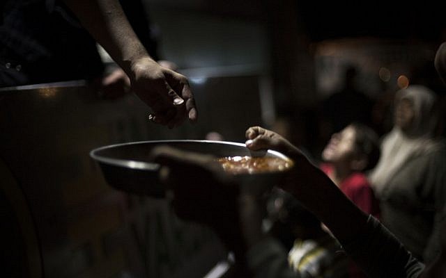 A Syrian boy, who fled his home with his family due to fighting between government forces and rebels, holds a plate with food to eat at a refugee camp near the Turkish border, Azaz, Syria, on Sunday, October 7, 2012 (photo credit:AP Photo/Manu Brabo) A Syrian boy, who fled his home with his family due to fighting between government forces and rebels, holds a plate with food to eat at a refugee camp near the Turkish border, Azaz, Syria, on Sunday, October 7, 2012 (photo credit:AP Photo/Manu Brabo)