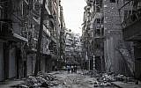 Syrian residents walk on a street among the debris of buildings damaged by heavy shelling in the southeast of Aleppo City, on October 27, 2012 (photo credit: AP Photo/Narciso Contreras)