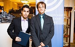 Natan Shuminov, left, and Kirill Samokhvalov volunteer at a Rosh Hashanah fundraiser last month in Moscow. The event reflected the growing involvement of local Jews in supporting their own communities. (Ilya Dolgopolsky via JTA)