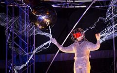 Magician David Blaine stands inside an apparatus surrounded by a million volts of electric currents streamed by tesla coils during his 72-hour 'Electrified: 1 Million Volts Always On' stunt on Pier 54, Friday, Oct. 5, 2012, in New York (photo credit: AP/John Minchillo)