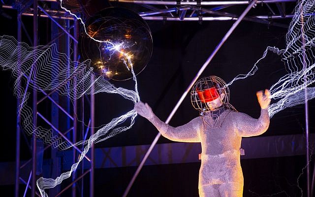 Magician David Blaine stands inside an apparatus surrounded by a million volts of electric currents streamed by tesla coils during his 72-hour 'Electrified: 1 Million Volts Always On' stunt on Pier 54, Friday, Oct. 5, 2012, in New York (photo credit: AP/John Minchillo)