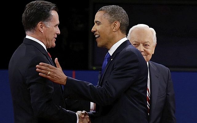 President Barack Obama and Republican challenger Mitt Romney shake hands at Monday night's foreign policy debate, while moderator Bob Schieffer looks on (photo credit: Charlie Neibergall/AP) President Barack Obama and Republican challenger Mitt Romney shake hands at Monday night's foreign policy debate, while moderator Bob Schieffer looks on (photo credit: Charlie Neibergall/AP)