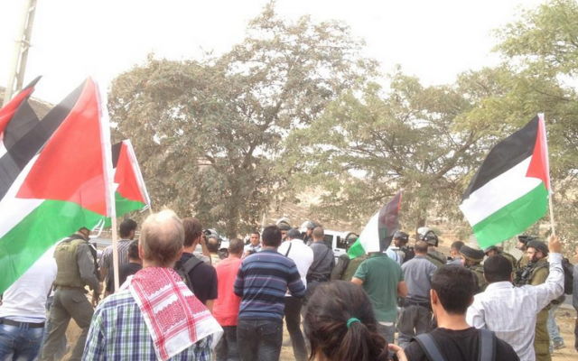 Protesters near the Rami Levy supermarket in the Sha'ar Binyamin industrial zone in the West Bank call for a boycott of settlement goods. (photo credit: Muhannad Alazzeh/Twitter)