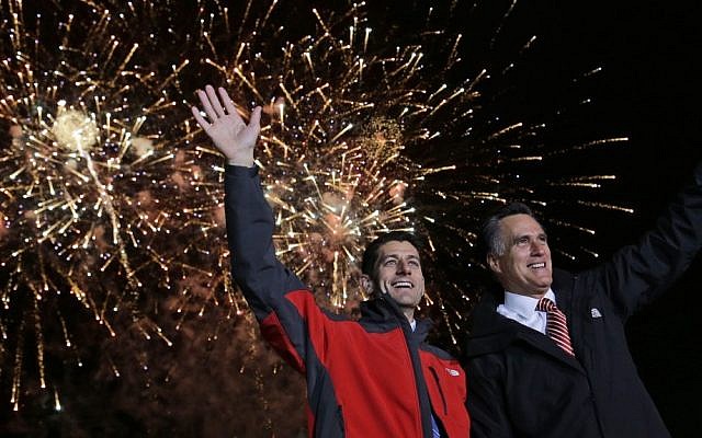 Republican presidential candidate Mitt Romney, right, and his vice presidential running mate, Rep. Paul Ryan, wave as fireworks go off at a campaign event in North Canton, Ohio on Friday (photo credit: AP/Charles Dharapak)